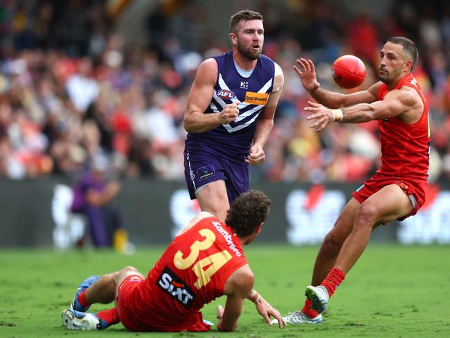 Luke Ryan handballs under pressure.