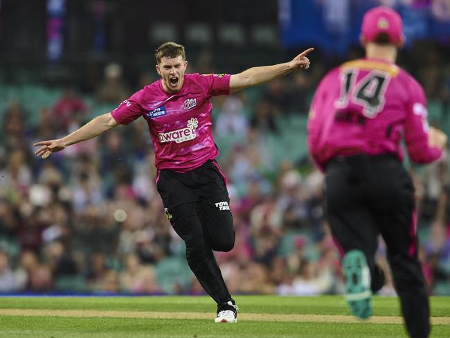 SYDNEY, AUSTRALIA - DECEMBER 28: Hayden Kerr of the Sixers celebrates after taking the wicket of Shaun Marsh of the Renegades during the Men's Big Bash League match between the Sydney Sixers and the Melbourne Renegades at Sydney Cricket Ground, on December 28, 2022, in Sydney, Australia. (Photo by Brett Hemmings/Getty Images)