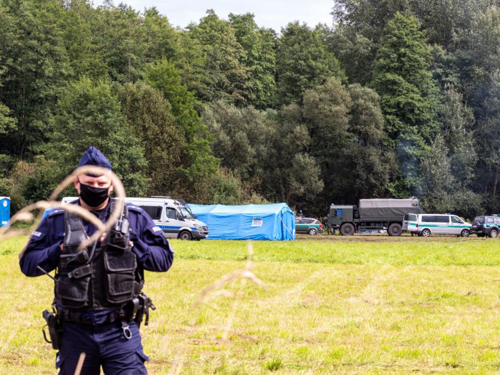 Polish Army Soldiers encircle a group of immigrants from Afghanistan at the Belarusian border and prevent their entry to the country in Usnarz Gorny, Poland.