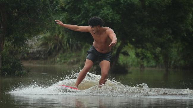 Paeroa Paul has fun in the floodwaters at Flooded Gum Park at Pacific Pines. Picture: Glenn Hampson