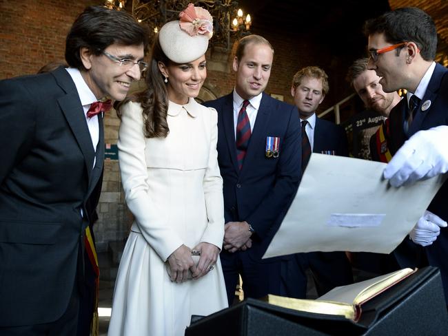 Outgoing Belgian Prime Minister Elio Di Rupo, Duchess of Cambridge Catherine, Britain's Prince William, and Britain's Prince Harry are seen at Mons' city hall during commemorations marking 100 years since the invasion of Belgium by Germany at the start of World War I. AFP PHOTO / BELGA / DIRK WAEM