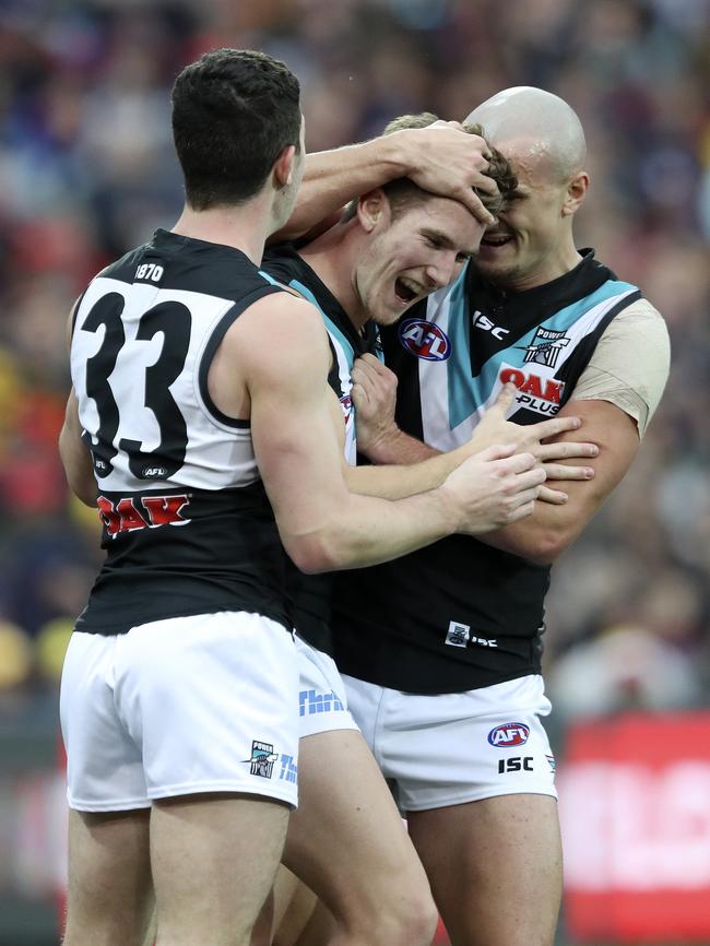 Kane Farrell celebrates the second of his three first-term goals with Darcy Byrne-Jones and Sam Powell-Pepper. Picture: SARAH REED