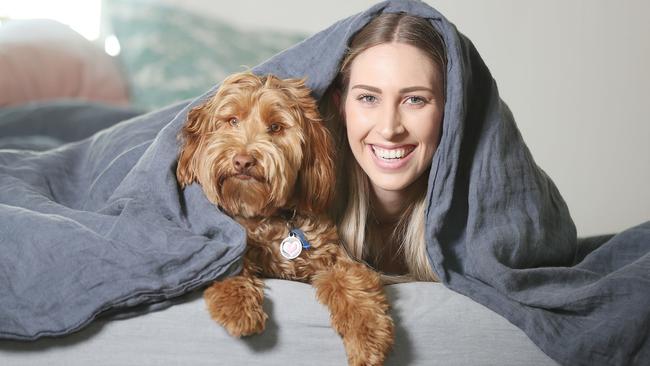 Rhiannon Frater knows the value of a good dog cuddle, especially with her labradoodle Pippi. Picture: Annette Dew