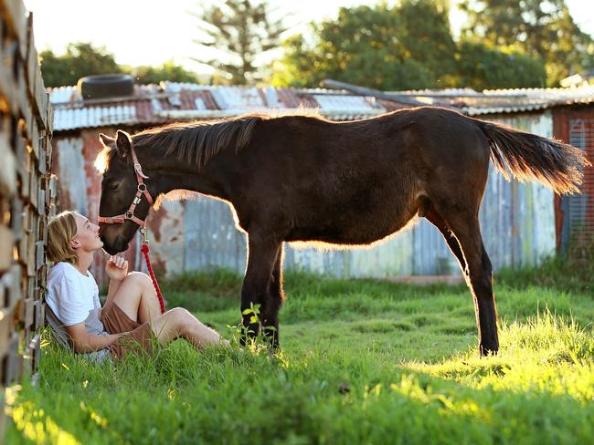 Errol Bousfield 19, with Zander the 5-month-old Mt Kosciuszko Brumby, at Warriewood. Picture: Troy Snook