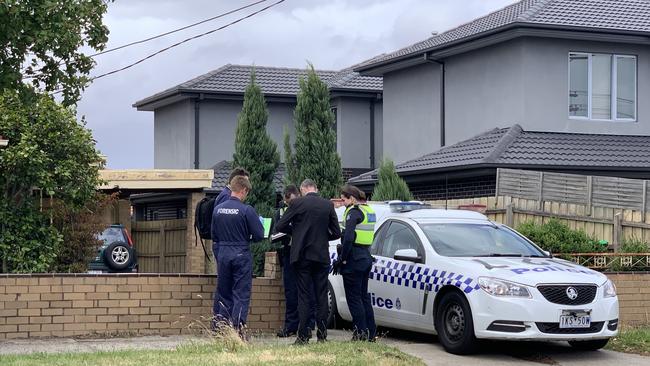 Forensic police work alongside homicide detectives at a Gladstone Road brick home. Picture: Brianna Travers