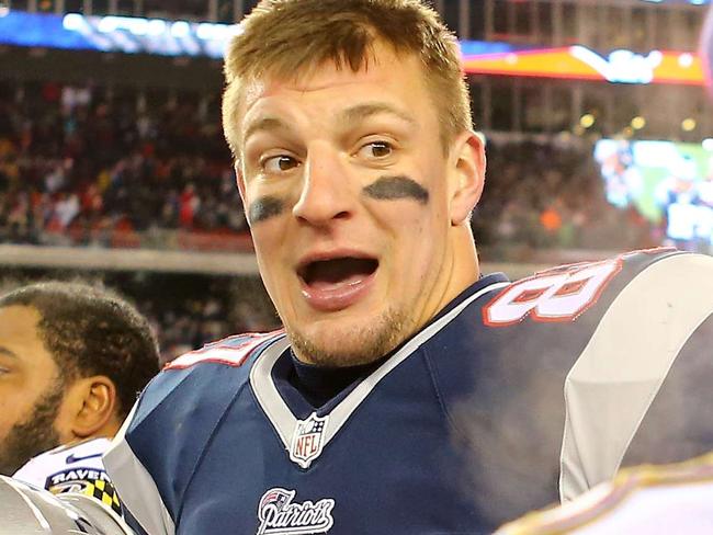 FOXBORO, MA - JANUARY 10: Rob Gronkowski #87 of the New England Patriots talks to members of the Baltimore Ravens following the 2015 AFC Divisional Playoffs game at Gillette Stadium on January 10, 2015 in Foxboro, Massachusetts. Maddie Meyer/Getty Images/AFP == FOR NEWSPAPERS, INTERNET, TELCOS & TELEVISION USE ONLY ==
