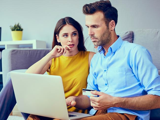 A couple talking about their finances at home. Picture: iStock.