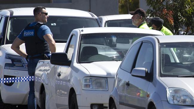 Police speak to workers in the area. Picture: Sarah Matray