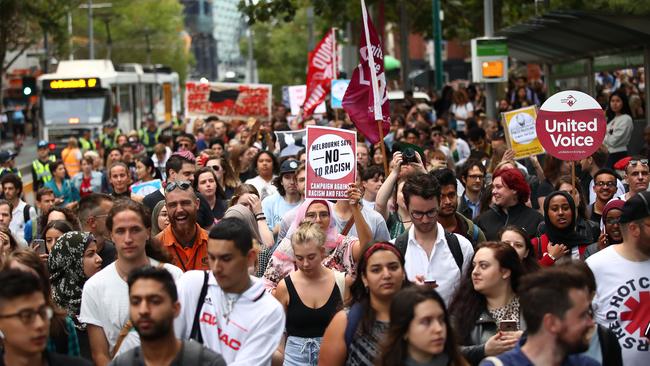 Protesters hold placards aloft as they march during the Stand Against Racism rally in Melbourne in 2019. Picture: Scott Barbour/Getty Images