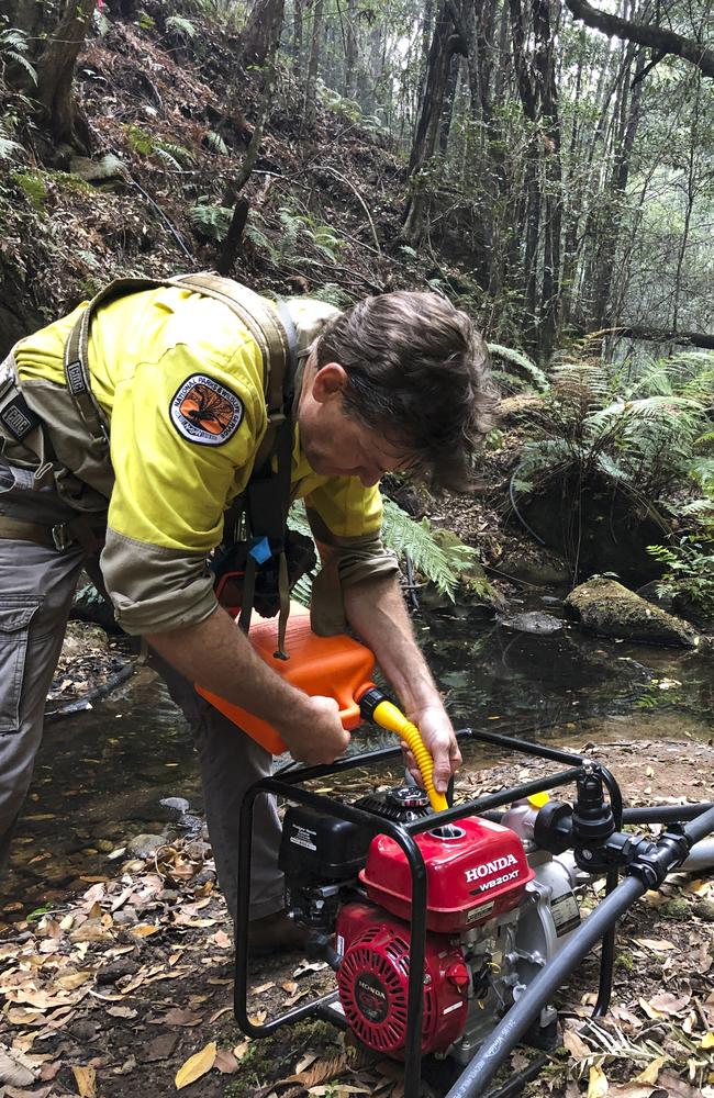 A member of the team that helped save the Wollemi pines operates a pump. Pictures: Supplied/Matt Kean