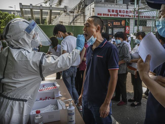 Amid a new outbreak, a man is tested for coronavirus in Beijing. Picture: Getty Images