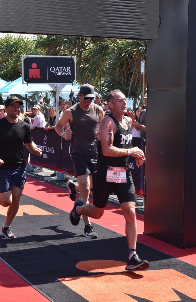 Athletes crossing the finish line at the Sunshine Coast Ironman 70.3 2023.