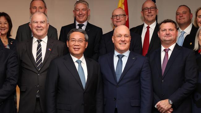 China's Premier Li Qiang (centre left) and New Zealand Prime Minister Christopher Luxon (centre right) pose for a photograph with the New Zealand China Council at Auckland War Memorial Museum on Friday. Picture: Fiona Goodall / Getty Images