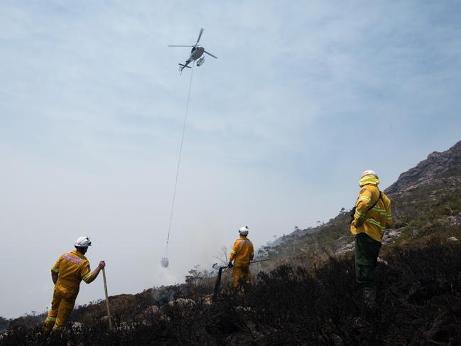 A waterbombing helicopter brings a load of water to the Gell River fire. Picture: WARREN FREY/TASMANIA FIRE SERVICE