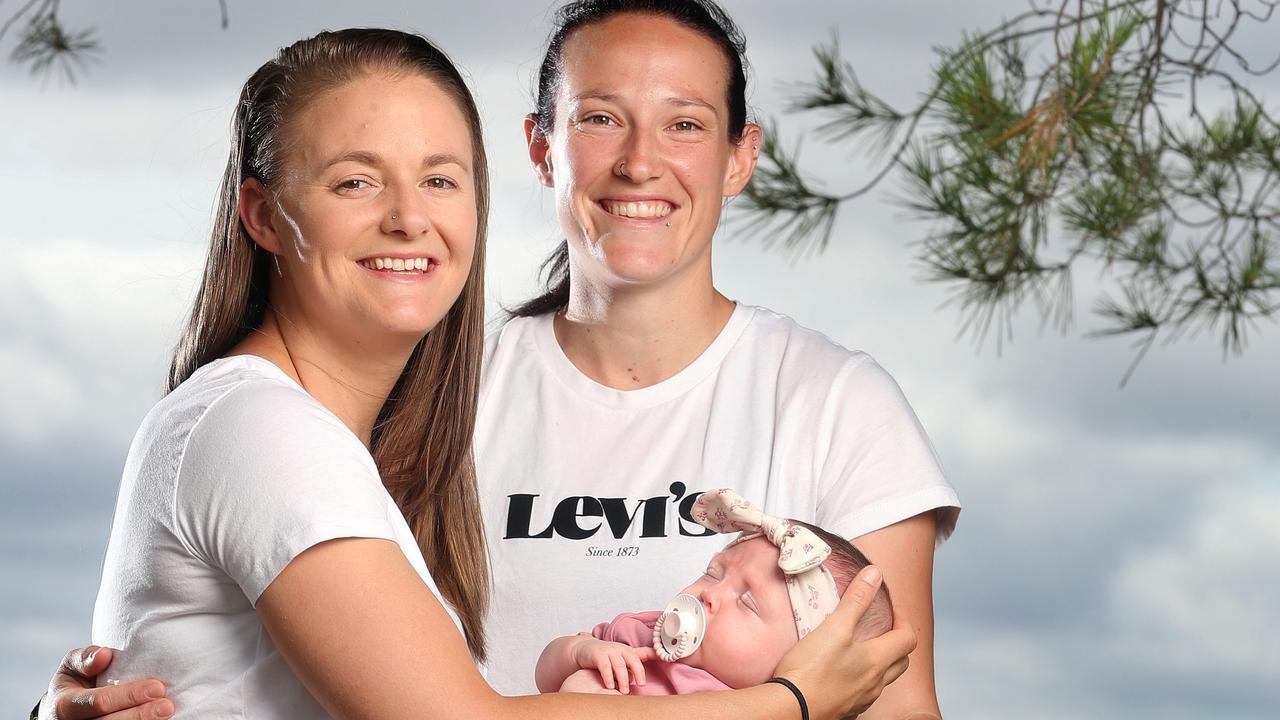 Australian international cricketer Megan Schutt poses with her wife Jess and their daughter Rylee