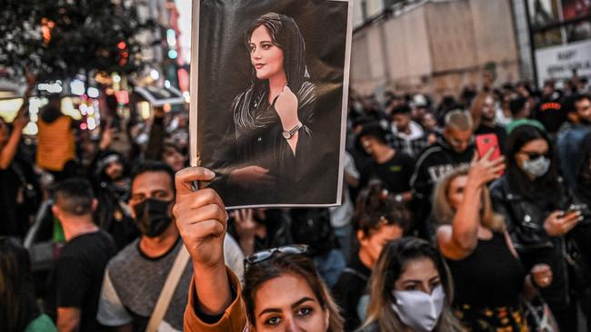 A protester holds a portrait of Mahsa Amini during a demonstration in Tehran. Picture: AFP