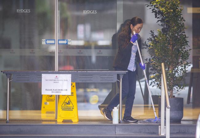 A cleaner at the entrance to the Rydges in July. Picture: Wayne Taylor