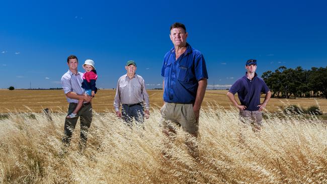 Chris Johns (centre) with his son Mitch and granddaughter Evie, 4, father Max and son Lachie on their property in Dooen in Western Victoria. Picture: Aaron Francis