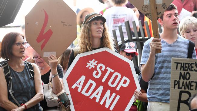 Anti-Adani coal mine protesters engage in a sit-in protest outside the Queensland government headquarters in Brisbane on December 12. Picture: AAP/Dan Peled