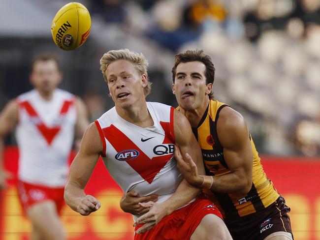 Sydneys Isaac Heeney clears by hand in front of Finn Maginness on Sunday. Picture: Michael Klein