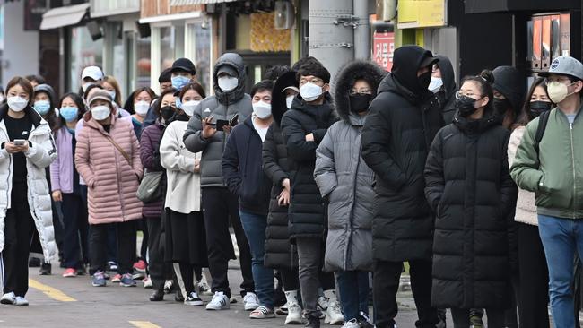 People wait in line to buy face masks from a store at the Dongseongro shopping district in Daegu, South Korea on Thursday Picture: AFP)