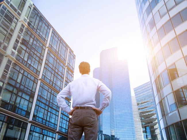 career concept, business background, man looking at office buildings