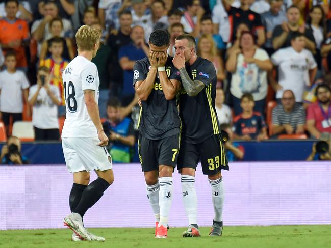 Juventus' Portuguese forward Cristiano Ronaldo (C) reacts after receiving a red card during the UEFA Champions League group H football match between Valencia CF and Juventus FC at the Mestalla stadium in Valencia on September 19, 2018. (Photo by JOSE JORDAN / AFP)
