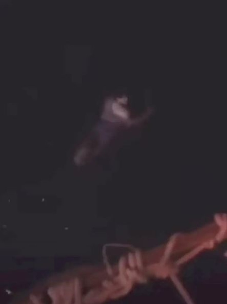 Haunting video footage shows the teen swimming away from a rescue buoy as onlookers shout for him to grab the device. Some spotted a ‘shark-like’ creature in the water. Picture: Supplied