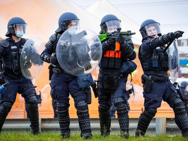 Riots police monitor the approaching rally. Picture: Mark Stewart