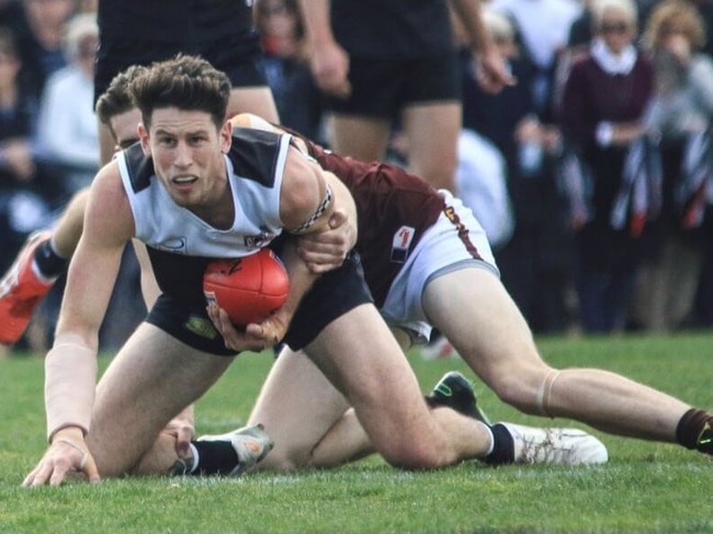 Ringwood captain Trent Farmer is caught in a tackle in the Eastern Football League (EFL). Picture: Davis Harrigan