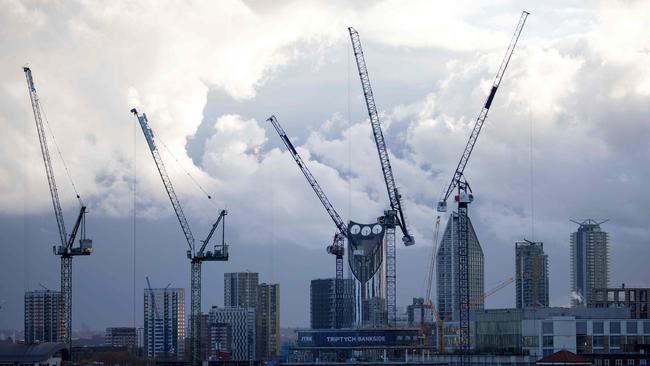 Cranes dominate a cloudy sky in south London. Britain's economy rebounded by a record 15.5 per cent in the third quarter. Picture: AFP