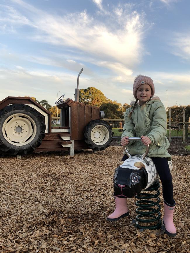 Wynter plays in the farm-themed area of the new playground. Picture: Onkaparinga Council