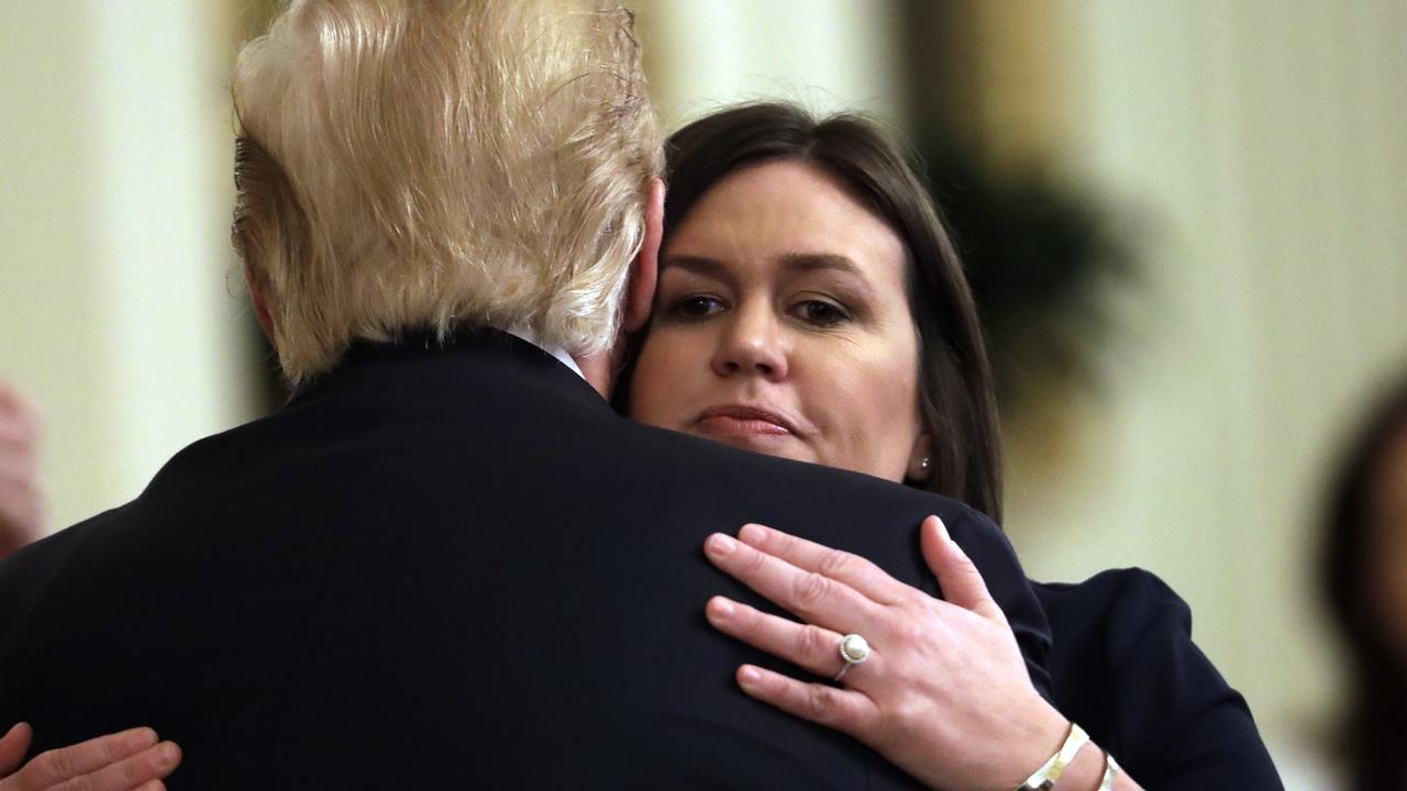 President Donald Trump hugs outgoing press secretary Sarah Sanders. Picture: AP