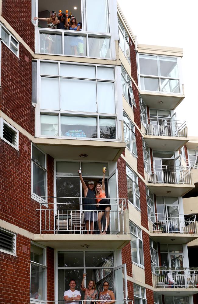 Residents in Rose Bay took to their balconies, including (top apartment) Stevo, Olivia and Sophie Sidoti with friend Bianca Seale, (middle) Ed Ho and Rhiannon Armitage and (bottom) Paul Tomsic, Jennifer Tosich and Claire Ward. Picture: Toby Zerna