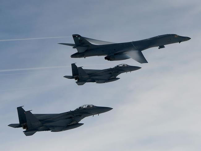 A US Air Force B-1B Lancer bomber (top) flies with South Korean jets over the Korean Peninsula during a joint live fire drill on July 8. Picture: South Korean Defence Ministry via Getty Images