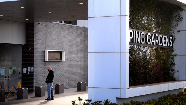 The son of a resident waits outside Epping Gardens Aged Care Home for news of his parent. Picture: Andrew Henshaw