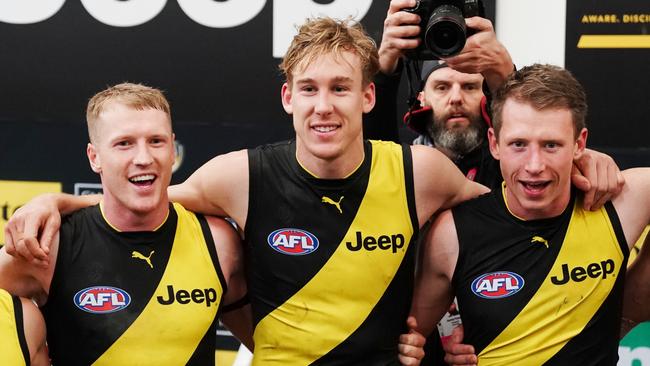 Josh Caddy (left) Tom Lynch (centre) and Dylan Grimes of the Tigers sing the club song after winning during the Round 25 AFL match between the Richmond Tigers and the Brisbane Lions at the MCG in Melbourne, Sunday, August 25, 2019. (AAP Image/Michael Dodge) NO ARCHIVING, EDITORIAL USE ONLY