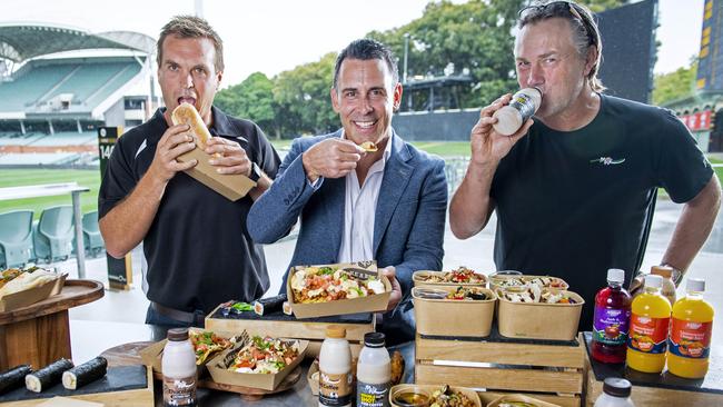 Fleurieu Milk Company general manager Nick Hutchinson, Adelaide Oval chief executive Nick Addison and Crows legend Tony Modra with a selection of food and drinks available at Adelaide Oval. Picture: Mark Brake