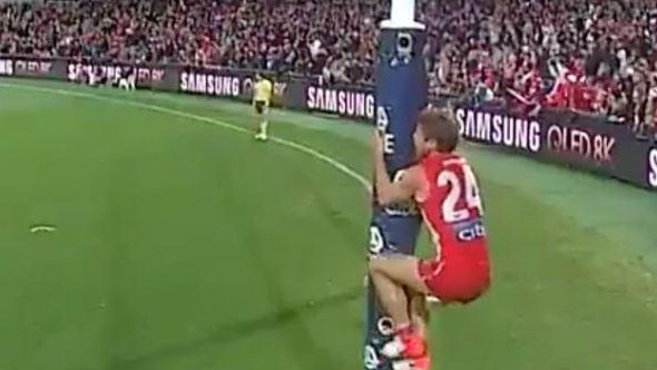 Dane Rampe jumps on the goalpost after the siren.