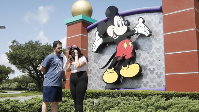 Michael Callahan and Sarah Breland at the Walt Disney World theme park entrance in Lake Buena Vista, Florida.