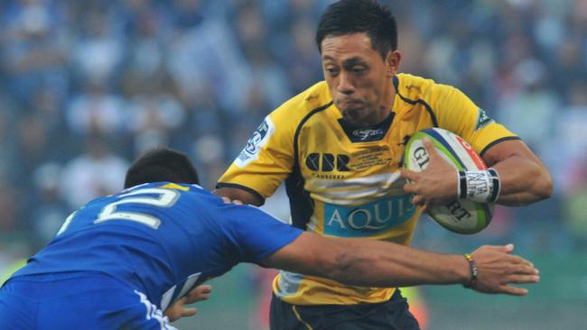 The Brumbies’ Christian Lealiifano fends the Stormers’ Damian de Allende over the weekend.