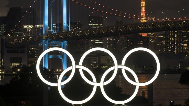 Illuminated Olympic rings in front of the Rainbow Bridge and Tokyo Tower marking one year to go to the rescheduled games Picture: Getty Images