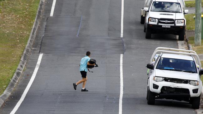 Pedestrians walk in the road on Coolibah street in Southport. Picture: Tertius Pickard