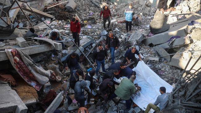 People pull out bodies of casualties from the rubble of a building destroyed in an Israeli strike on the Bureij camp for Palestinian refugees in the central Gaza Strip. Picture: AFP