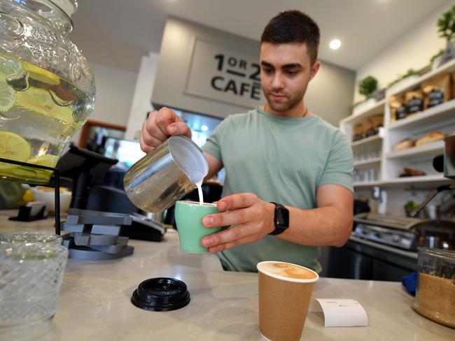 A barista is seen prepairing a coffee at a cafe in Canberra. Wages are going up for these works and others. Picture: AAP