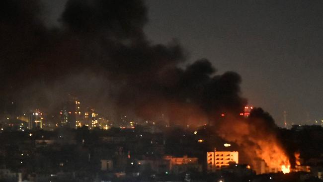 Smoke and flames rise from areas targeted by an Israeli air strike in Beirut’s southern suburbs. Picture: AFP.