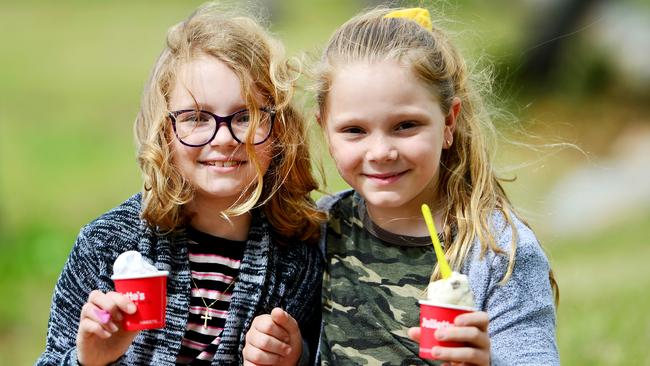 Ivy 9 and Hazel Smith 8, feel the chill of winter coming on, but still enjoy an ice cream.