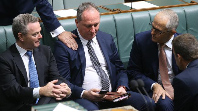 The Prime Minister and other ministers including Christopher Pyne console Barnaby Joyce yesterday in parliament. Picture: Kym Smith