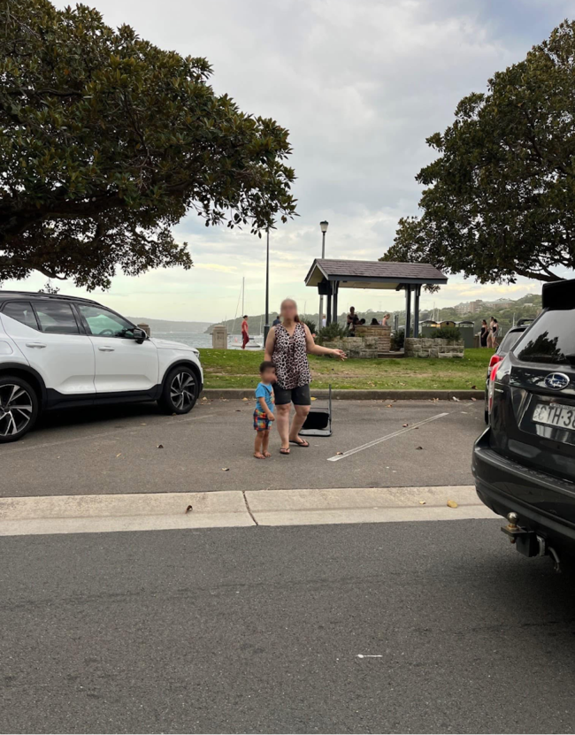 A woman stands in a car space with her child. Picture: Facebook/MosmanLiving