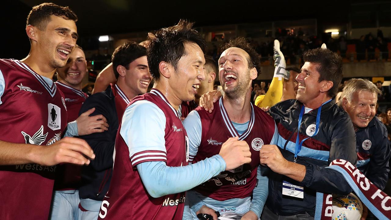 APIA Leichhardt Tigers players celebrate knocking out the current A-League champs.